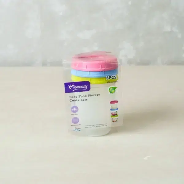 Single baby food storage container with yellow, pink, and blue lids stacked neatly on top, placed on a flat surface.