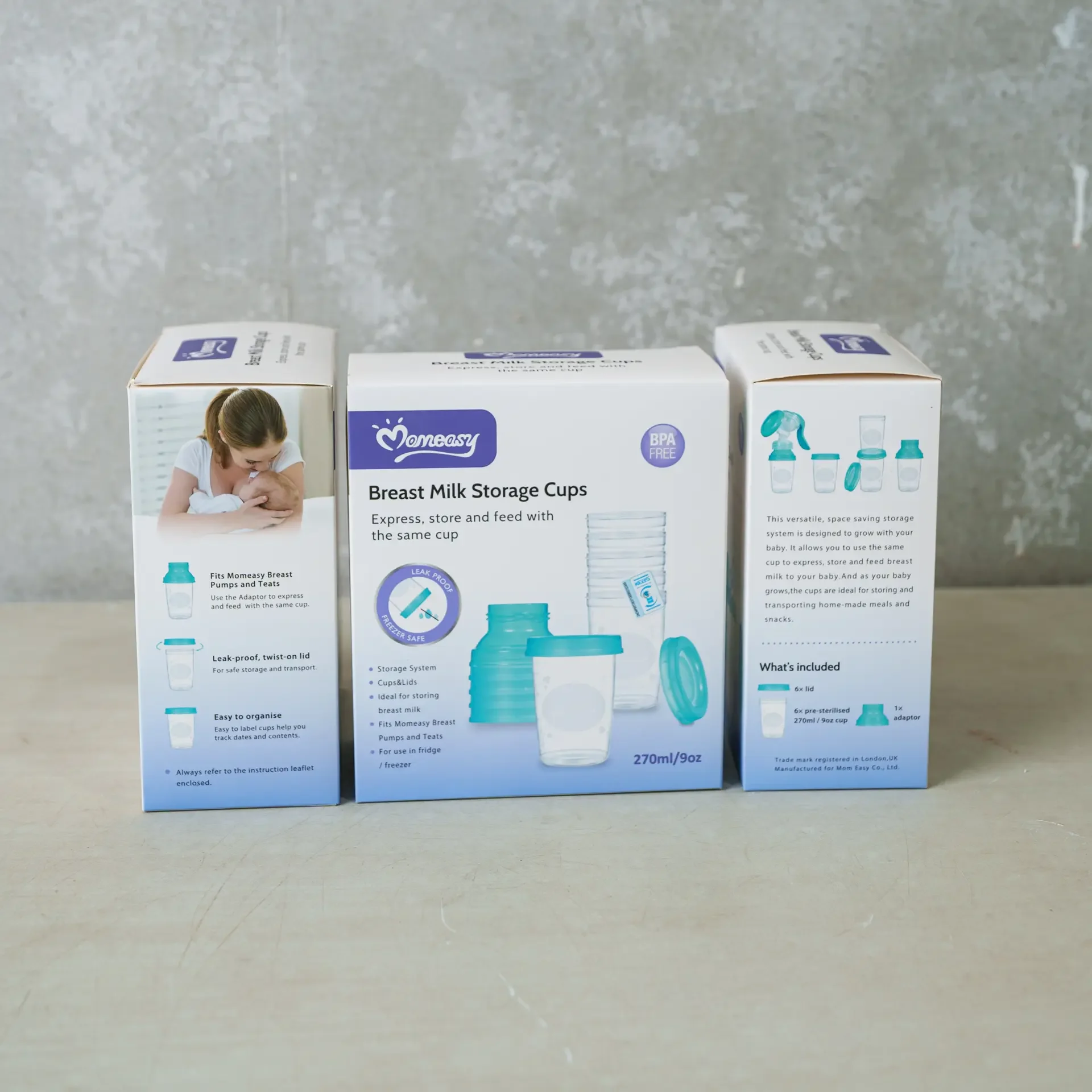 A box set of Momeasy Breast Milk Storage Cups displayed on a light surface, showing the front and side packaging. The product includes BPA-free 270ml/9oz storage cups with leak-proof lids, designed for expressing, storing, and feeding breast milk using the same cup. The sides highlight features and compatibility with Momeasy breast pumps and teats.